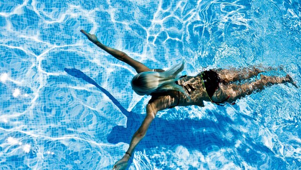 A swimmer in a pool. - RedDoorz @ Benesari 2 (Kuta)