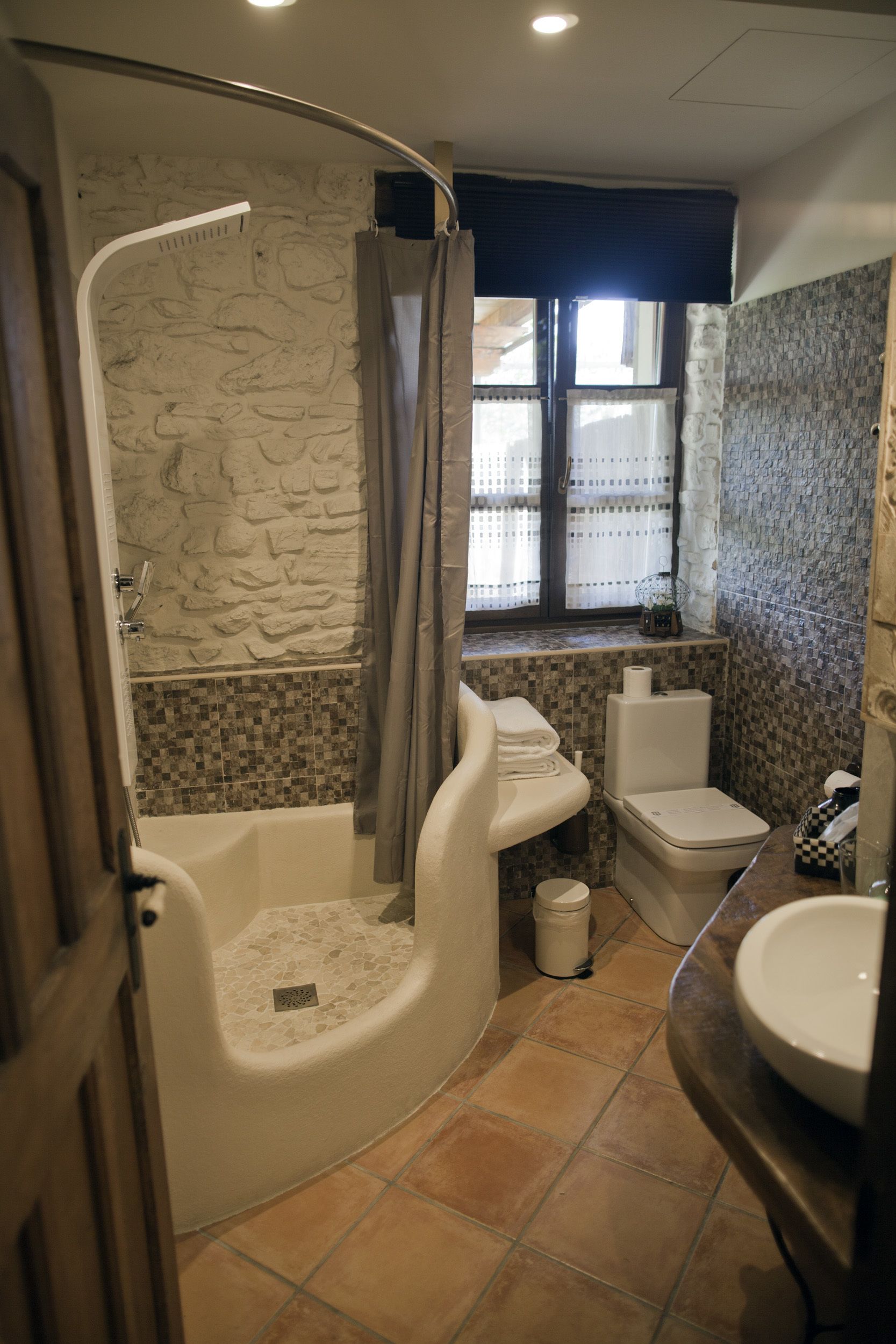 A bathroom with a bathtub, toilet, and sink.