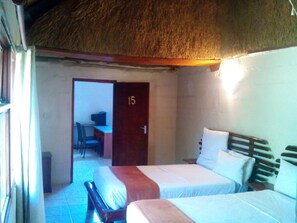 A room with two beds, a desk, and a chair. - Northgate Lodge (Nata)