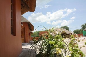 A traditional building with a thatched roof and a wooden door.