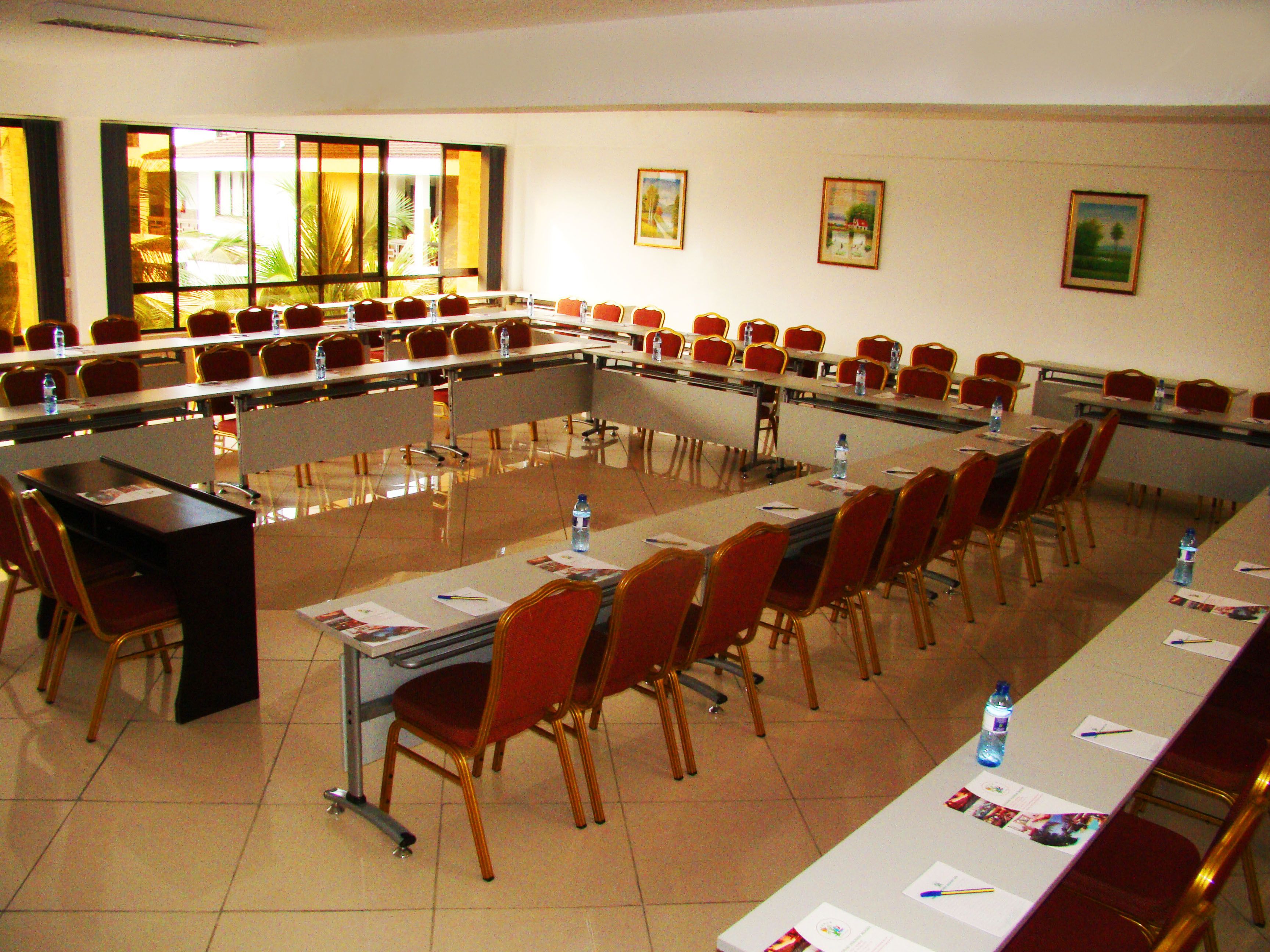 A conference room with a long table, chairs, and water bottles.