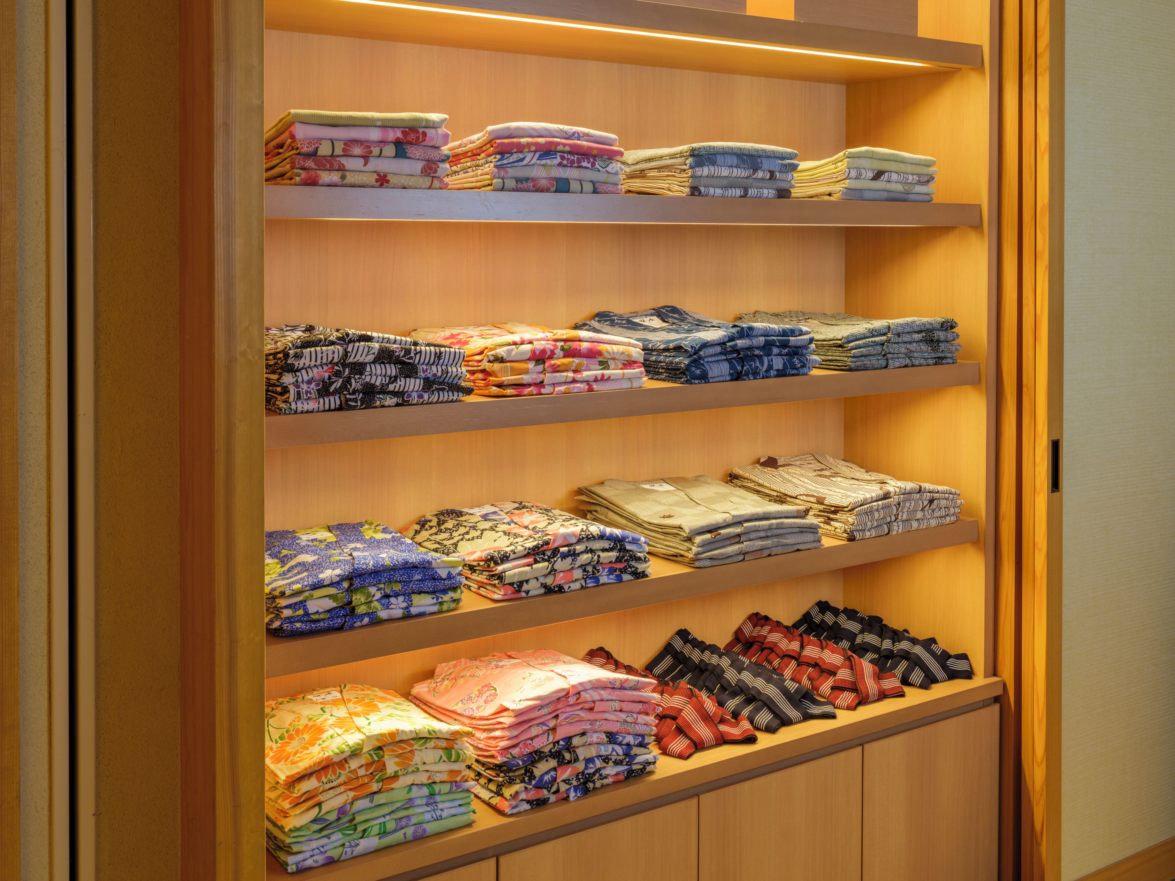 A neatly organized fabric display with various folded textiles.