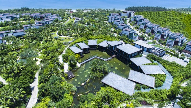 A resort with modern buildings, a central water feature, and a view of the ocean. - Grand Hyatt Sanya Haitang Bay Resort and Spa (Sanya)