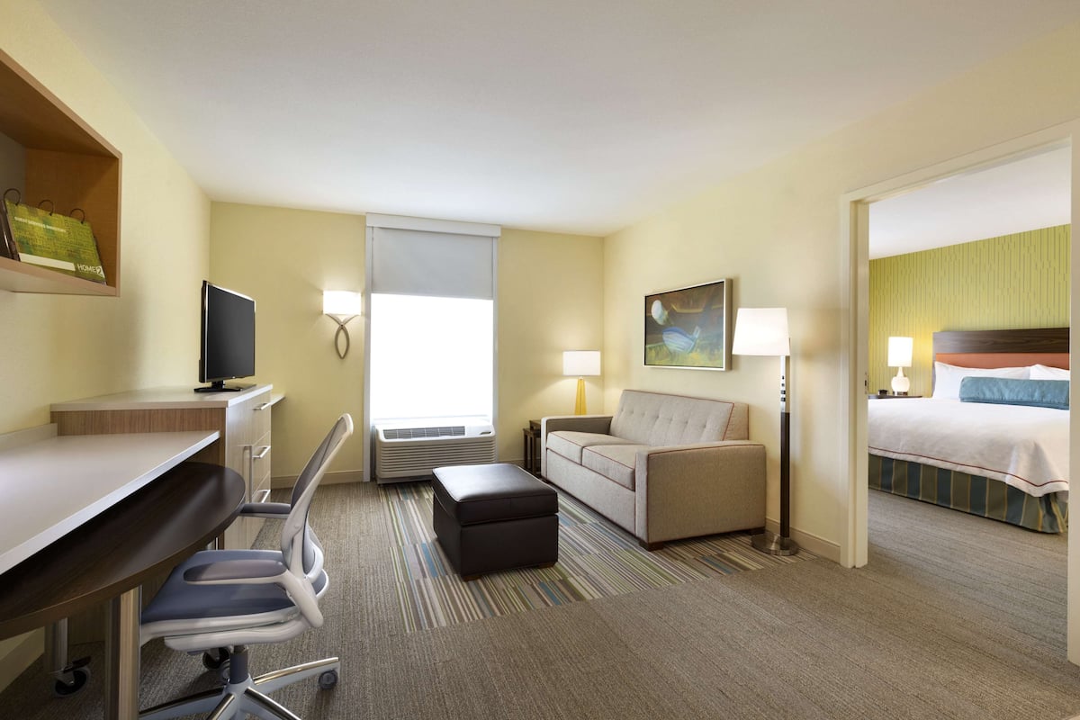 Premium bedding, desk, laptop workspace, blackout drapes