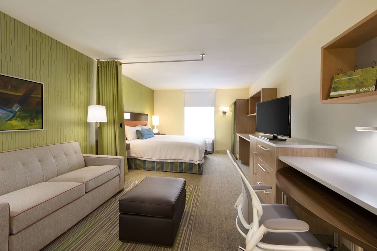 Premium bedding, desk, laptop workspace, blackout drapes