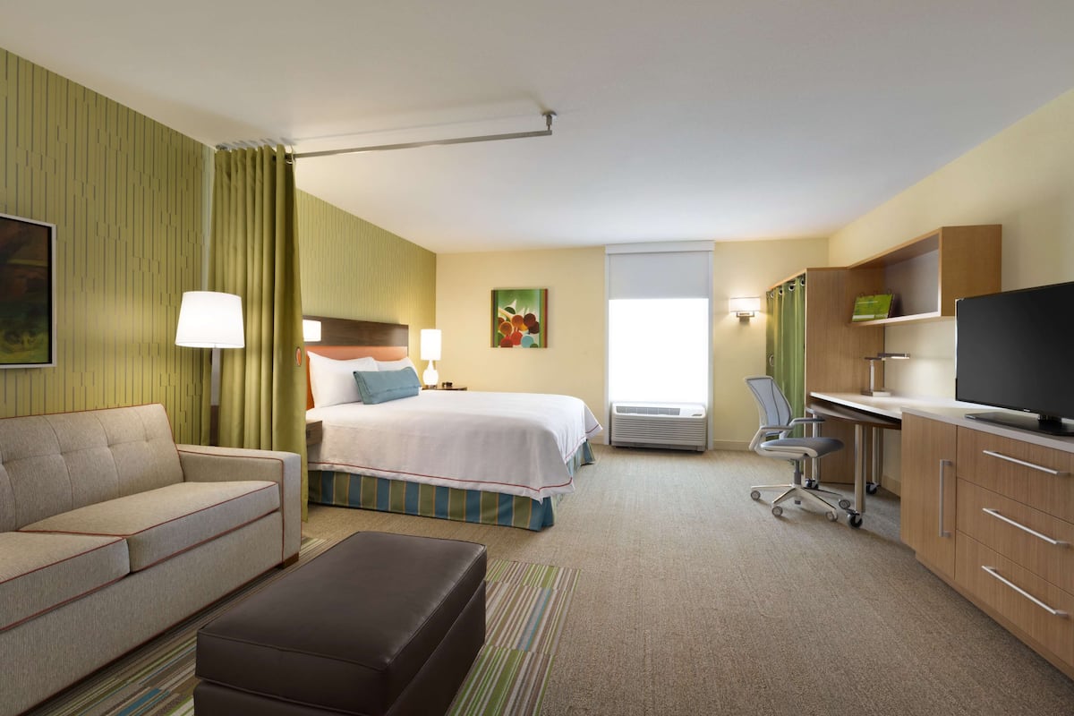 Premium bedding, desk, laptop workspace, blackout drapes