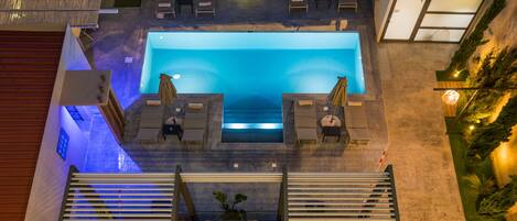 Seasonal outdoor pool, open 8:00 AM to 8:00 PM, pool umbrellas