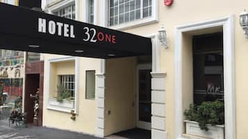 Entrada de un hotel con un letrero que dice 'HOTEL 32 ONE'.