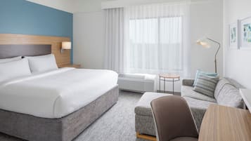 Premium bedding, desk, laptop workspace, blackout drapes