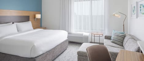Premium bedding, desk, laptop workspace, blackout drapes