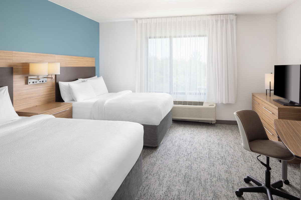 Premium bedding, desk, laptop workspace, blackout drapes