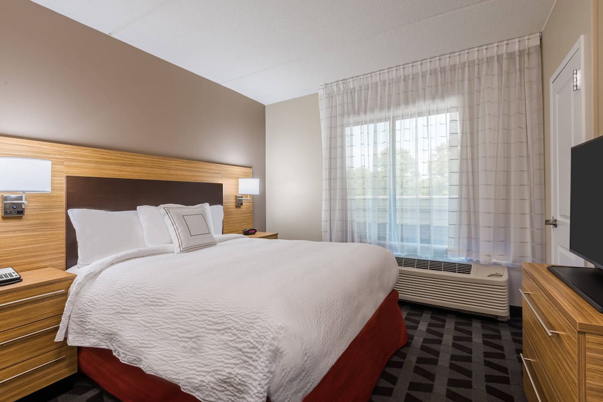 Premium bedding, desk, laptop workspace, blackout curtains