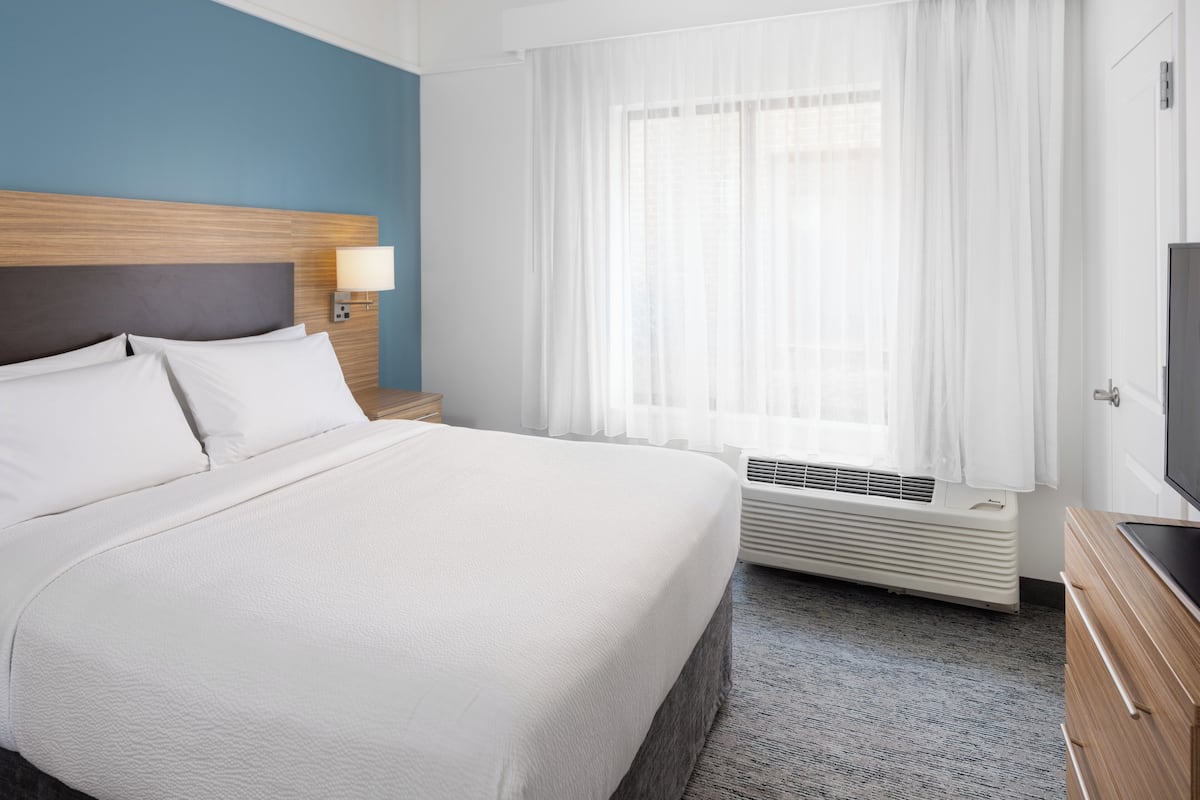 Premium bedding, desk, laptop workspace, blackout drapes