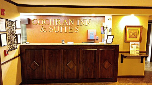 Un mostrador de recepción con un letrero que dice "COCHRAN INN & SUITES".