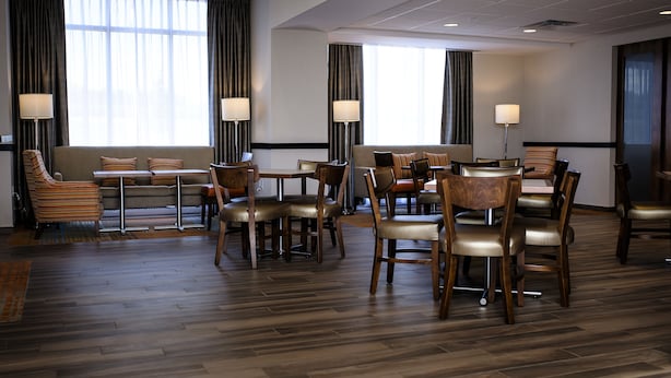 A hotel lobby with a seating area, tables, and lamps. - Hampton Inn & Suites by Hilton Truro (Millbrook First Nation Reserve)
