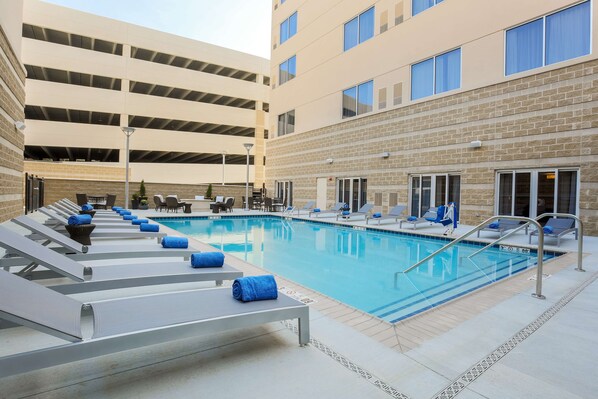 Seasonal outdoor pool, open 10:00 AM to 10:00 PM, pool loungers