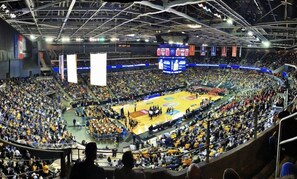 A large indoor stadium with multiple levels of seating, a central basketball court, and a scoreboard. - DoubleTree by Hilton Evansville (Evansville)