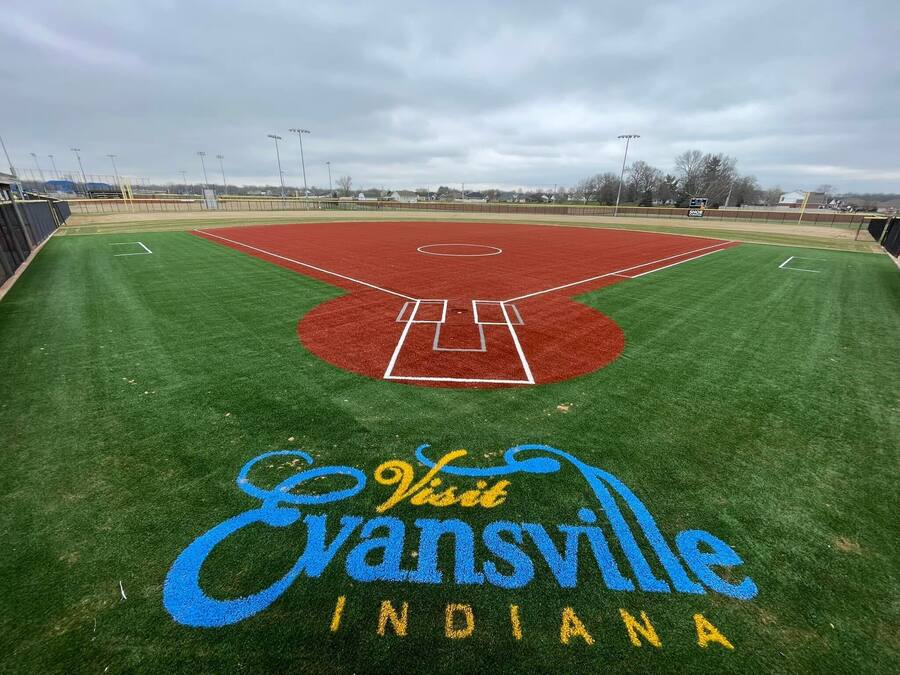 A baseball field with the text "Evansville Indiana" painted on the grass.