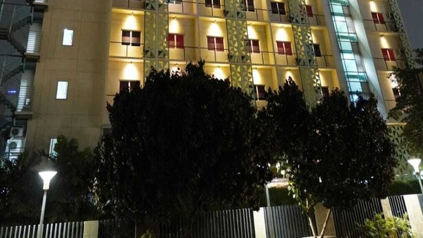 A multi-story hotel with a modern facade, illuminated windows, and a prominent signage indicating it is a hotel. - Hotel Cikini (Jakarta)