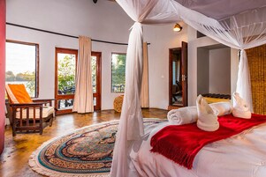 Un dormitorio con cama con dosel, un ventanal y vistas al exterior.
