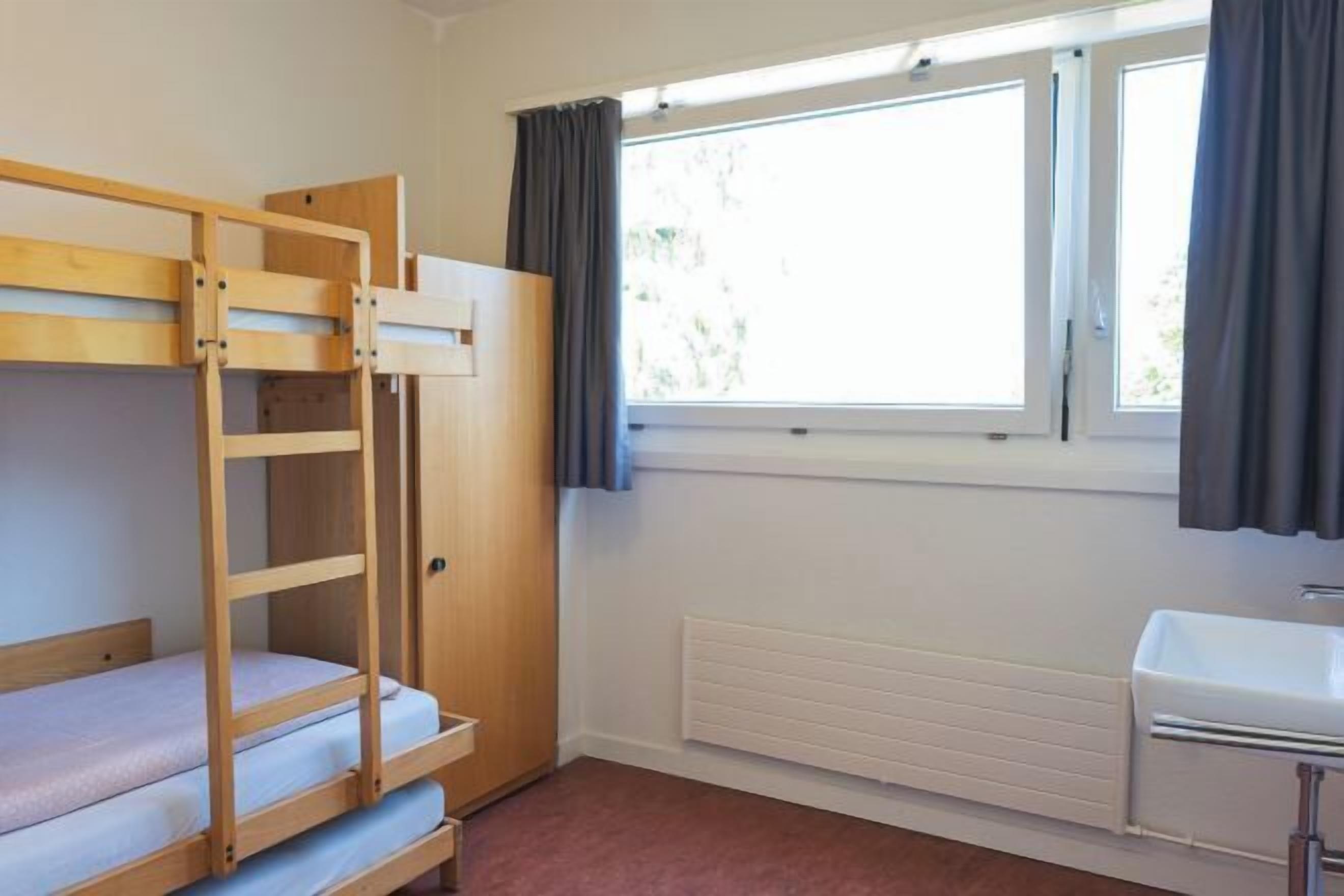 Desk, iron/ironing board, bed sheets