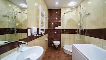 A modern bathroom with a sink, toilet, bathtub, and glass-enclosed shower.