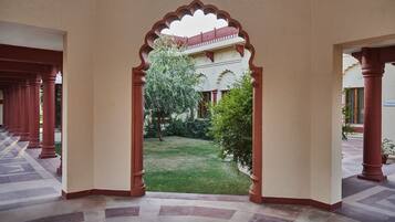 Un pasillo con vista a un jardín a través de un arco.