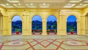 A spacious hall with ornate arches and a patterned floor, leading to a garden view. - The Ummed Jodhpur Palace Resort & Spa (Jodhpur)