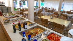 A buffet setup with various food items and condiments.