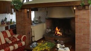 A cozy living room with a fireplace, a sofa, and a coffee table.
