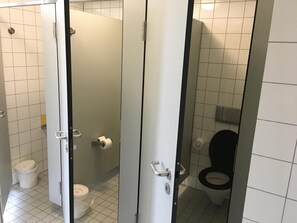 A restroom with a toilet, a bidet, and a shower stall. - Jugendherberge Aachen - Membership required (Aachen)
