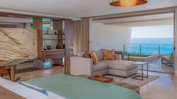 Una sala de estar moderna con sofá, mesa de centro y vista al mar.
