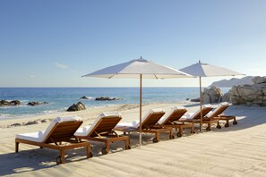 On the beach, sun loungers, beach umbrellas