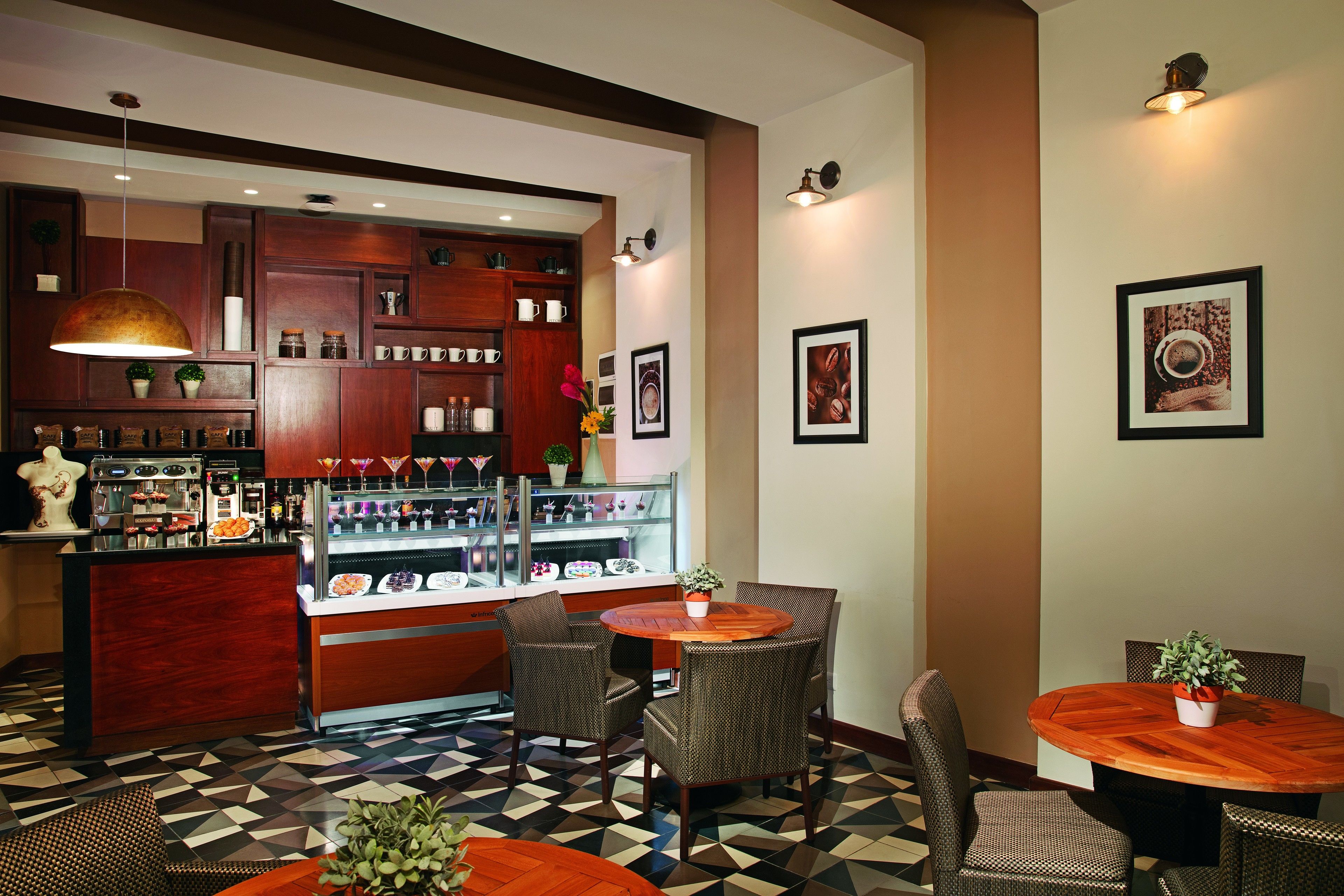 A bar area with a counter, bar stools, and a round wooden table with chairs.