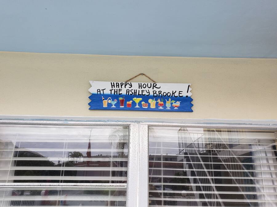 A wall sign with a message and drink illustrations.