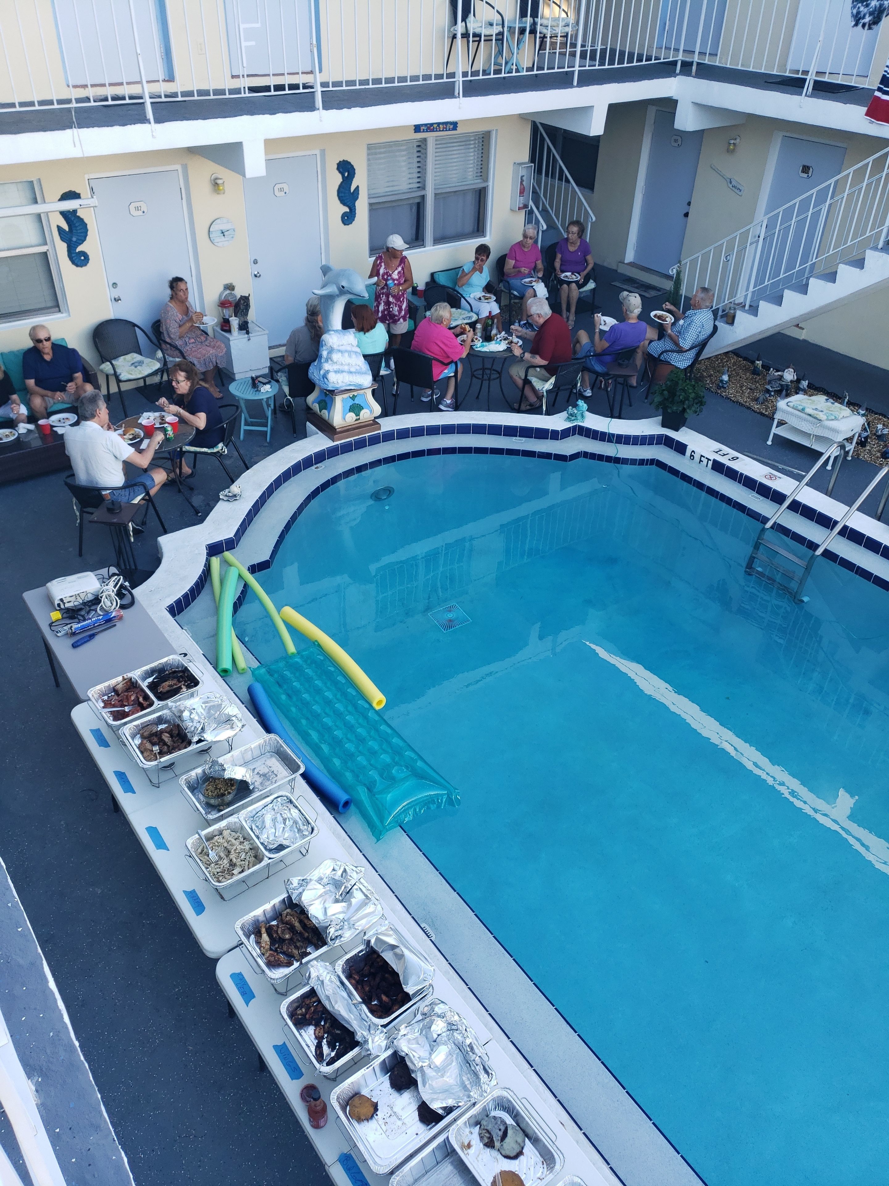 A poolside area with a dining setup and a pool.