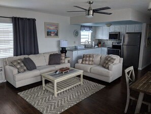 Deluxe Apartment, 1 Bedroom | Living room | 55-inch LED TV with cable channels, TV, books - Ashley Brooke Beach Resort (Deerfield Beach)