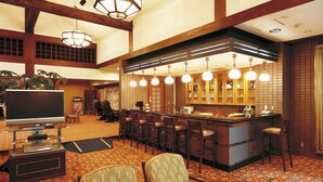 A hotel lobby with a bar area, seating, and a television. - Watarase Onsen Hotel Sasayuri (Tanabe)