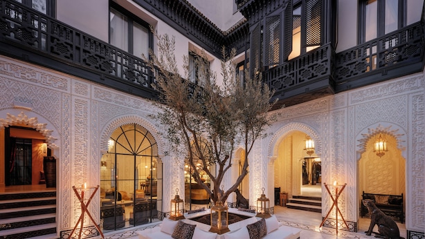 A courtyard with a central seating area, ornate walls, and a tree. - Riad Kheirredine (Marrakech)