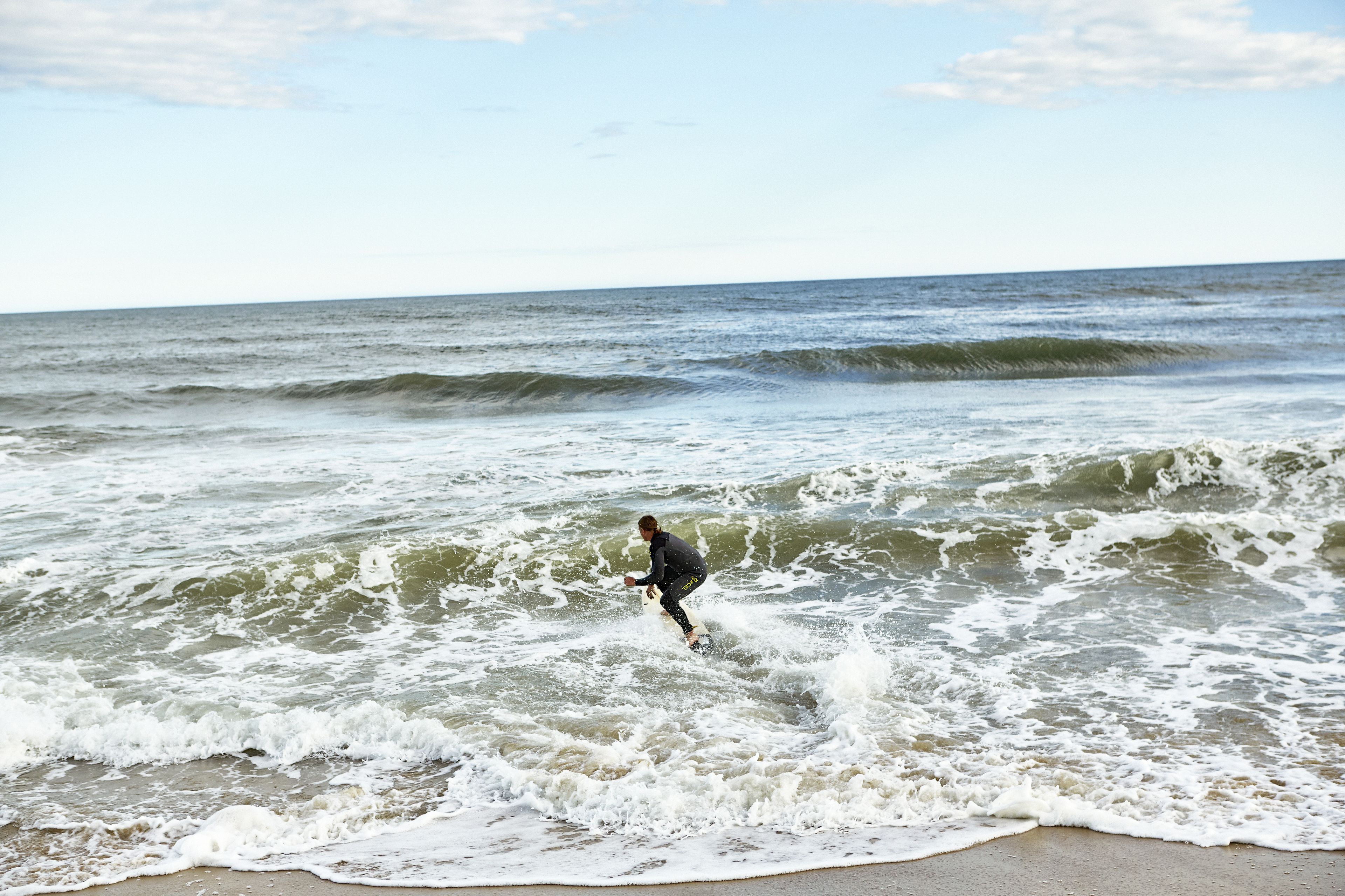A person surfing on a wave in the ocean.