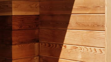 A corner of a wooden cabin with horizontal wooden planks.