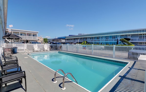 Seasonal outdoor pool, open 9:00 AM to 9:00 PM, pool umbrellas