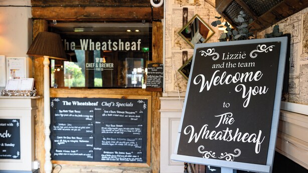 A sign welcoming visitors to The Wheatsheaf, featuring a menu board with chef's specials. - Wheatsheaf Hotel by Chef and Brewer Collection (Basingstoke)