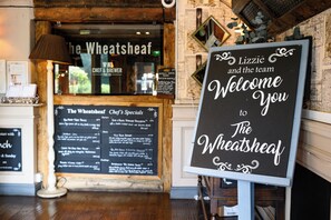 A sign welcoming visitors to The Wheatsheaf, featuring a menu board with chef's specials. - Wheatsheaf Hotel by Chef and Brewer Collection (Basingstoke)