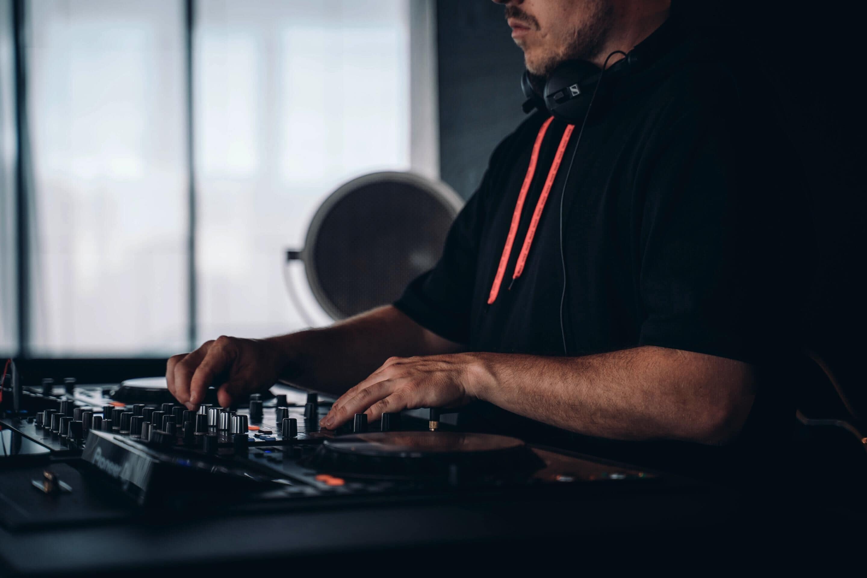 A person operating DJ equipment.