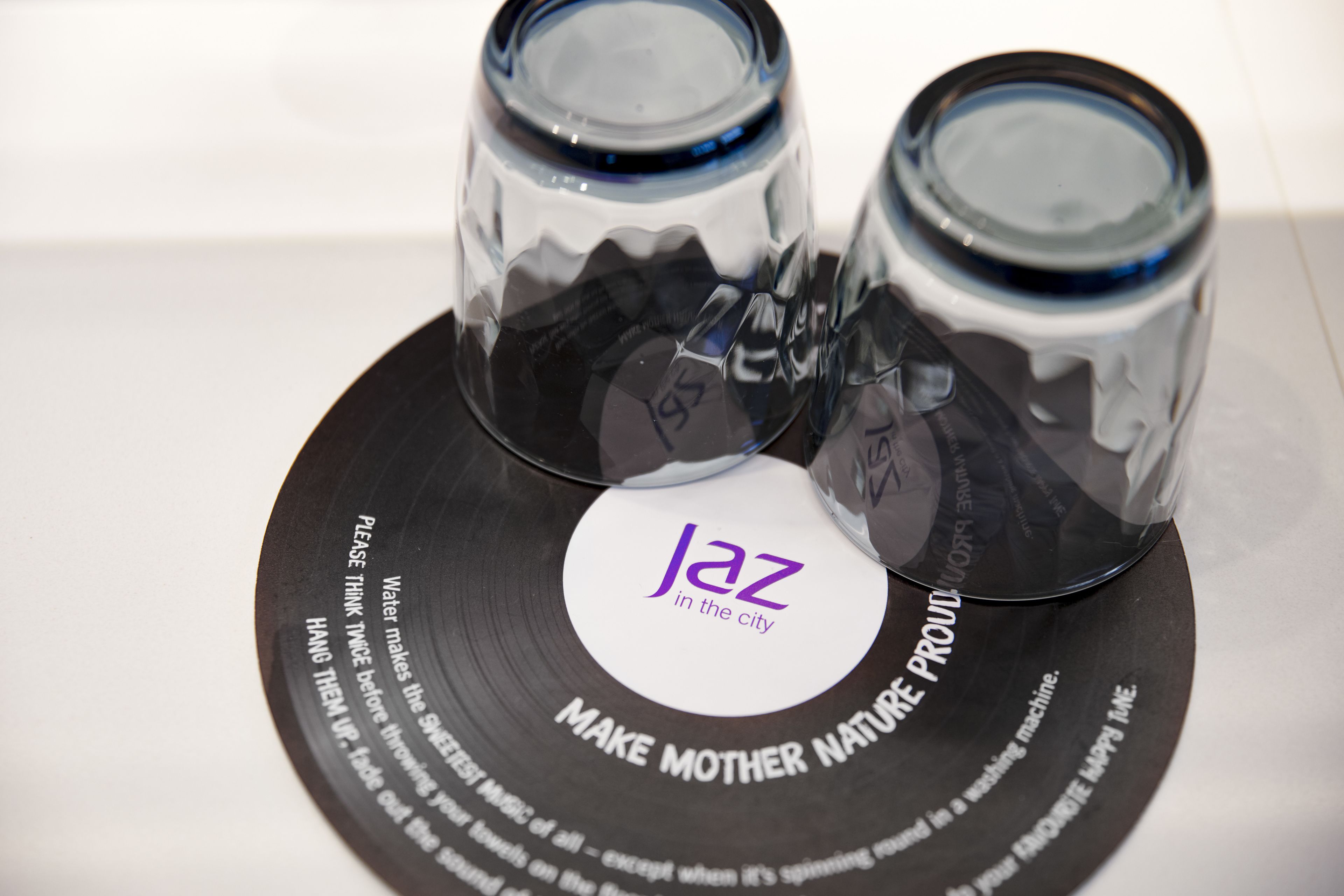 A vinyl record with a label that reads "jaz in the city" and the phrase "MAKE MOTHER NATURE PROUIL".