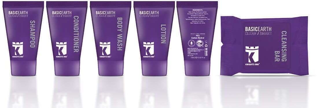 A row of five purple tubes labeled with different skincare products from the brand 'BASICEARTH'.