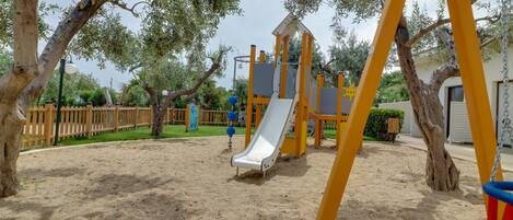 A playground with a slide and swings.