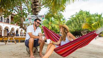 On the beach, white sand, sun loungers, beach umbrellas