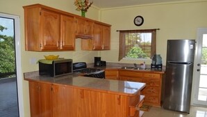 Apartment, 2 Bedrooms | Private kitchen | Coffee/tea maker, full-size fridge, microwave, oven - Sea Pearl Vacation Suites (San Pedro)